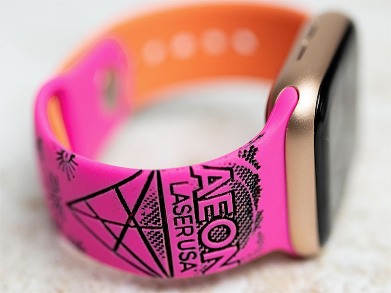 custom fluorecent pink watch band with 曰逼 logo engraved on it